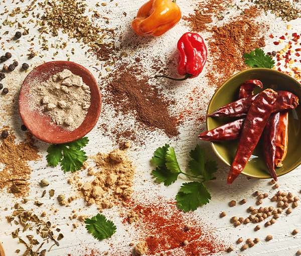 Overhead photo of scattered spices, peppers and other ingredients often used in Mexican cuisine