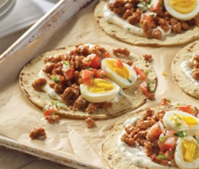 meats inspired by global flavors served on a breakfast tortilla wrap
